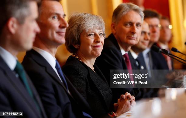 Britain's Prime Minister Theresa May sits with members of her Cabinet, including Britain's Defence Secretary Gavin Williamson , Britain's Foreign...