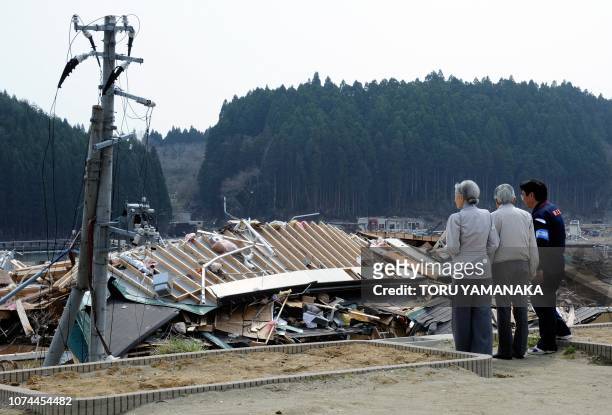 Minamisanriku Mayor Jin Saito , Japanese Emperor Akihito and Empress Michiko look at tsunami devastation from the Isatomae Elementary School in...