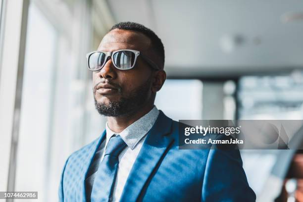 african american businessman wearing sunglasses in the board room - black suit sunglasses stock pictures, royalty-free photos & images