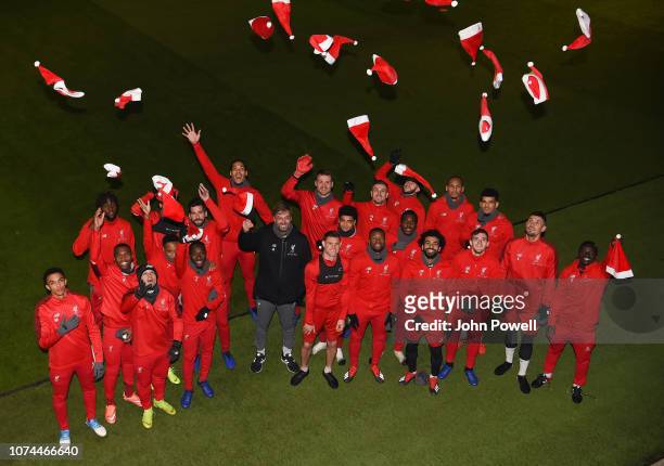 Members of Liverpool's first-team squad pose for their annual Christmas photo at Melwood Training Ground on December 20, 2018 in Liverpool, United...