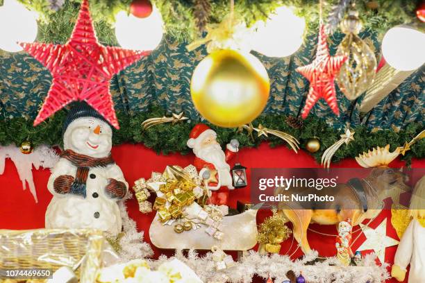 Snowman, Santa Claus with light on a sled with presents pulled by a reindeer. Christmas Market in the Northern Bavarian town of Bayreuth