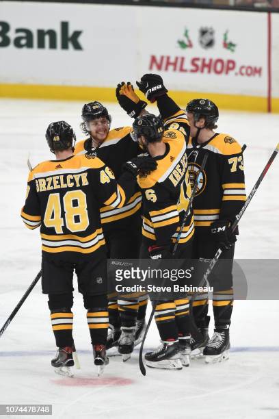 Matt Grzelcyk, David Pastrnak, David Krejci and Charlie McAvoy of the Boston Bruins against the Anaheim Ducks at the TD Garden on December 20, 2018...
