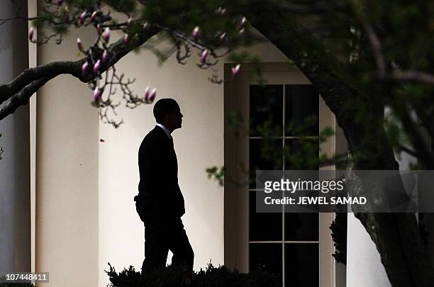 President Barack Obama walks to the Oval Office upon returning to the White House after speaking at a rally celebrating the passage and signing into...