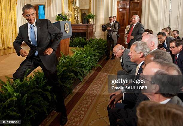 President Barack Obama steps off the stage to greet members of Congress after signing the Iran Sanctions Bill in the East Room of the White House in...