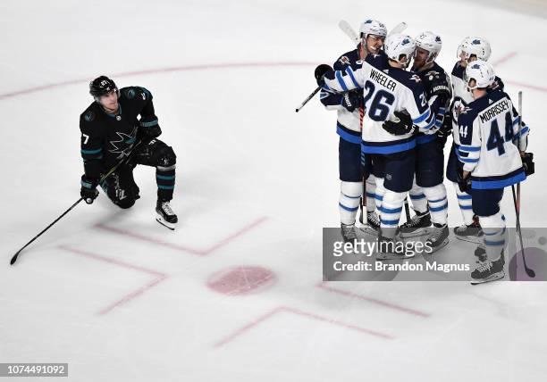 Joonas Donakoi of the San Jose Sharks looks up at the scoreboard as the Winnipeg Jets celebrate their victory at SAP Center on December 20 2018 in...