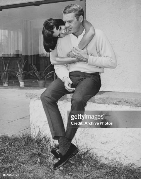 American actor Steve McQueen receives an embrace from his first wife, actress Neile Adams, circa 1965.