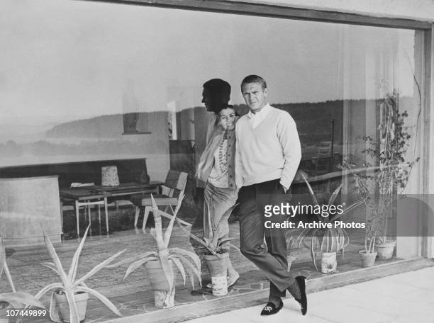 American actor Steve McQueen and his first wife, actress Neile Adams, separated by a windowpane, circa 1965.