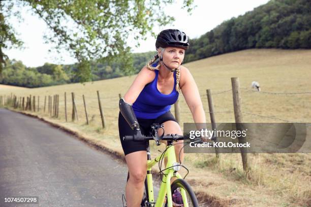 close up of female amputee cyclist - fitness or vitality or sport and women stock pictures, royalty-free photos & images