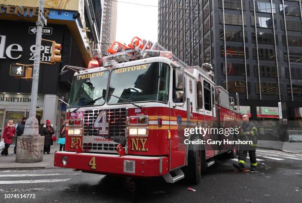 Fireman walks back to an FDNY fire engine as it tries to make a turn onto Broadway on November 28 in New York City.