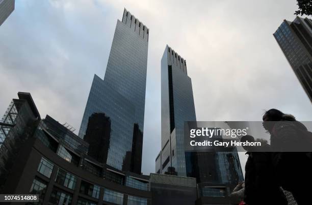 People walk past the Time Warner Center in Columbus Cirlce on November 28 in New York City.