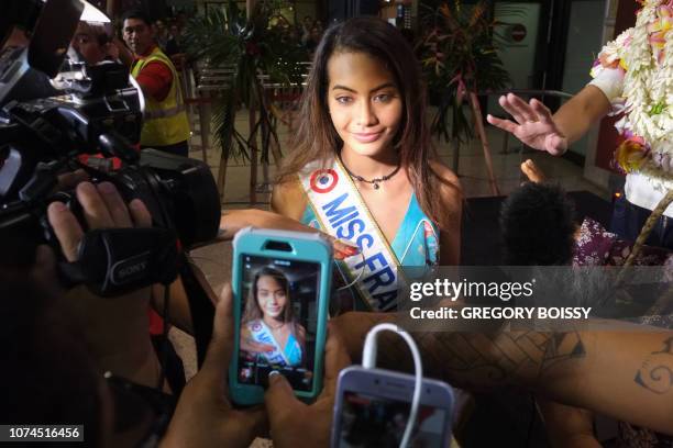 Miss France 2019 Vaimalama Chaves poses for fans during a welcoming ceremony upon her arrival at Papeete airport, on December 20, 2018 on the French...