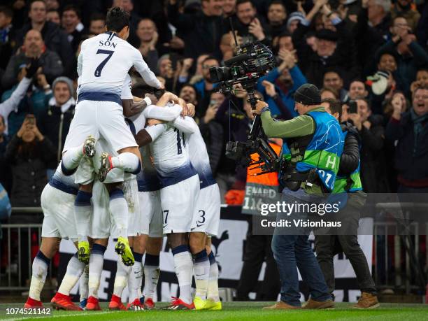 Christian Eriksen celebrates scoring the winning goal for Tottenham Hotspur and hsi mobbed by his team mates as a BT Sport steadicam television...