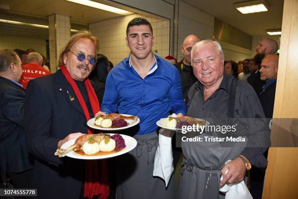 Frank Zander, Marco Huck and Ulli Wegner during the Frank Zander Christmas dinner for the homeless and people in need at Hotel Estrel Convention...