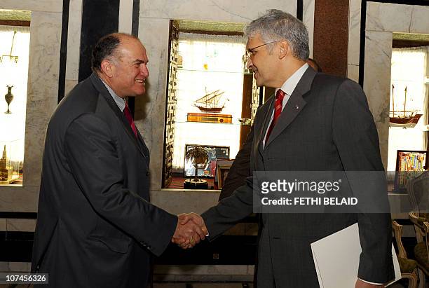 Tunisian development and International Cooperation Minister Mohamed Nouri Jouini greets Director General of the French Development Agency Dov Zerah...