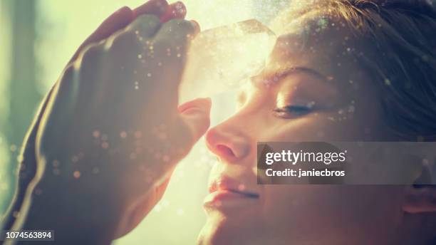 woman's head with a healing crystal. - spiritual healing stock pictures, royalty-free photos & images