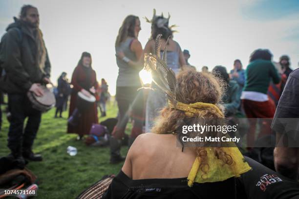 People dance as druids, pagans and revellers gather at Stonehenge, hoping to see the sun rise, as they take part in a winter solstice ceremony at the...