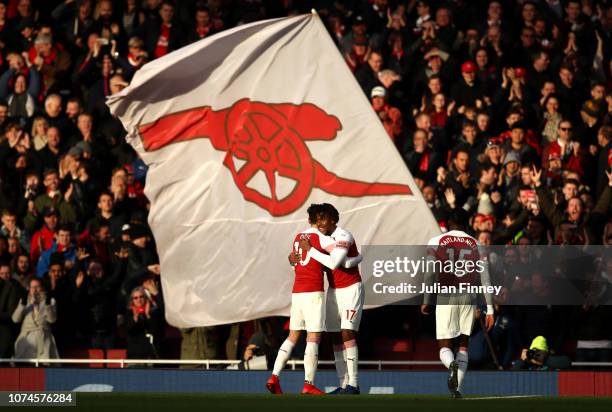 Alex Iwobi of Arsenal celebrates after scoring his team's third goal with Mesut Ozil of Arsenal during the Premier League match between Arsenal FC...