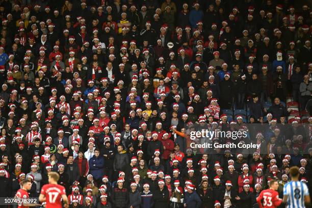Southampton fans wearing santa hats look on during the Premier League match between Huddersfield Town and Southampton FC at John Smith's Stadium on...