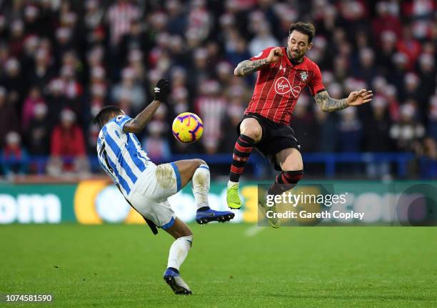 Danny Ings of Southampton and Beram Kayal of Brighton and Hove Albion battles for possession in the air during the Premier League match between...