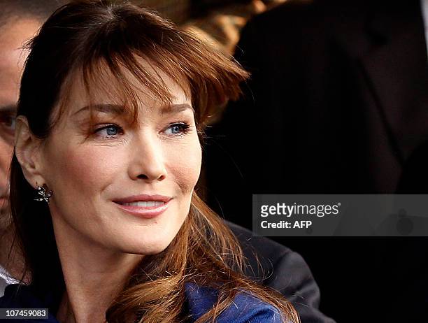 French first lady and global AIDS ambassador Carla Bruni-Sarkozy looks on as she leaves Naz Foundation care home for orphaned children with HIV/AIDS...