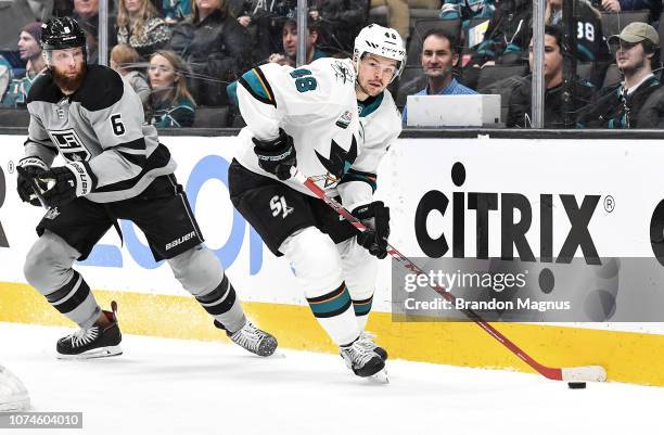 Tomas Hertl of the San Jose Sharks keeps the puck away from Jake Muzzin of the Los Angeles Kings at SAP Center on December 22 2018 in San Jose,...