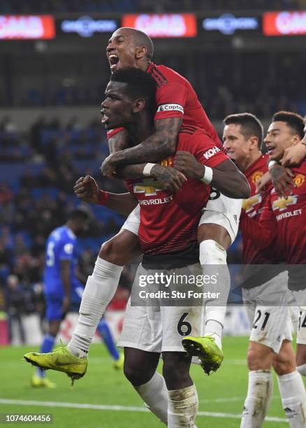 Manchester United players Ashley Young celebrates with Paul Pogba after the 5th goal during the Premier League match between Cardiff City and...