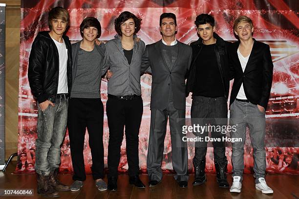 Boyband One Direction pose with Simon Cowell for a photocall to promote the X-Factor final held at The Connaught Hotel on December 9, 2010 in London,...