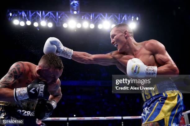 Josh Warrington punches Carl Frampton during the IBF World Featherweight Championship title fight between Josh Warrington and Carl Frampton at...