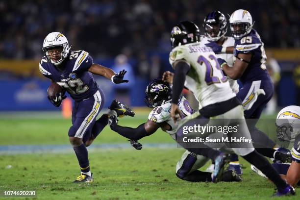 Justin Jackson of the Los Angeles Chargers eludes the tackle of Patrick Onwuasor of the Baltimore Ravens during the second half of a game at StubHub...