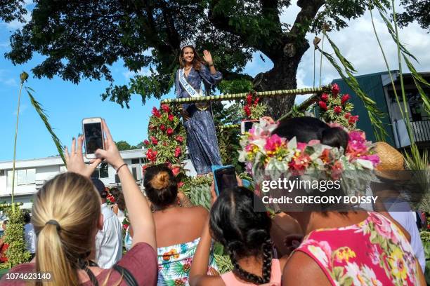 Miss France 2019 Vaimalama Chaves waves to people as she parades on a flower-covered float in Papeete, on December 22, 2018 on the French Polynesian...