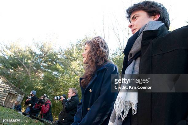 Skandar Keynes and Georgie Henley watch a lion get fed during the Smithsonian's National Zoo Lion Cub naming ceremony at Smithsonian National...
