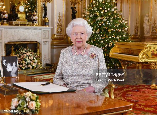 Queen Elizabeth II poses for a photo after she recorded her annual Christmas Day message, in the White Drawing Room at Buckingham Palace in a picture...