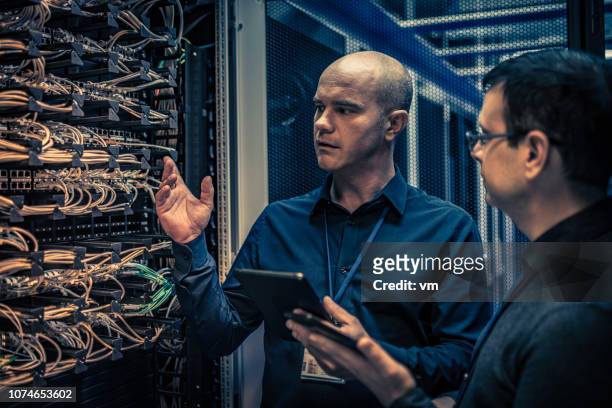 it technician explaining server configuration to a manager - network connection plug stock pictures, royalty-free photos & images
