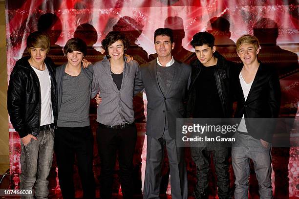 Liam Payne, Louis Tomlinson, Harry Styles, Zane Malik and Niall Horan of 'One Direction' together with Simon Cowell attend a photocall during the X...