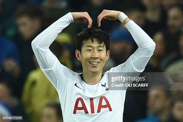 Tottenham Hotspur's South Korean striker Son Heung-Min celebrates with the Mobot pose of British athlete Mo Farah after scoring their first goal...