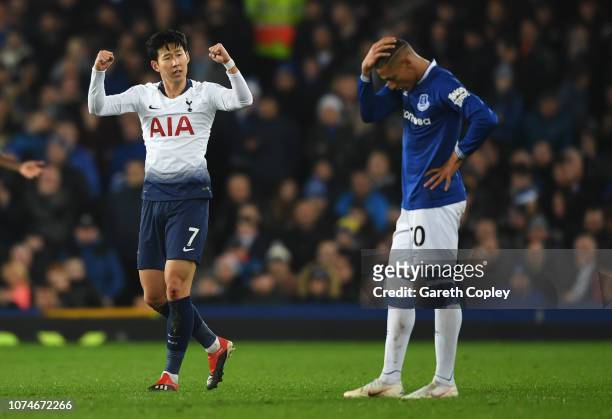 Heung-Min Son of Tottenham Hotspur celebrates after scoring his team's first goal as Richarlison of Everton looks dejected during the Premier League...