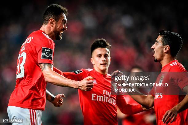 Benfica's Brazilian defender Jardel Vieira celebrates a goal with teammates Benfica's Argentine forward Franco Cervi and Benfica's defender Andre...