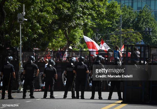 Police officers look at River fans on their way to the Monumental Stadium before the celebrations at Antonio Vespucio Liberti Stadium after winning...