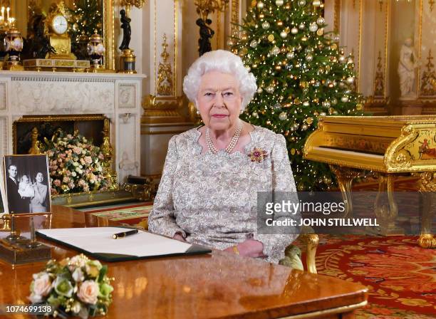 Picture released on December 24, 2018 shows Britain's Queen Elizabeth II posing for a photograph after she recorded her annual Christmas Day message,...