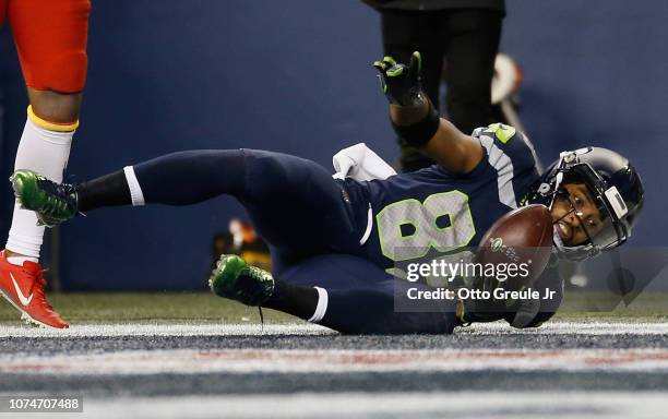 Doug Baldwin of the Seattle Seahawks reacts as he falls into the end zone after catching a touchdown pass to make it 24-17 in the third quarter of...