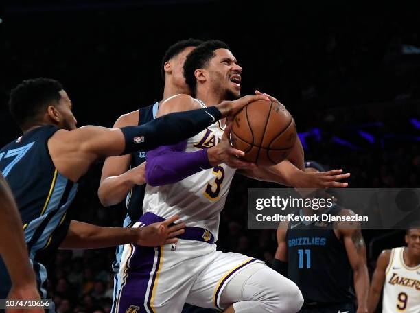 Josh Hart of the Los Angeles Lakers is fouled by Garrett Temple of the Memphis Grizzlies as he drives to the basket against Ivan Rabb of the Memphis...