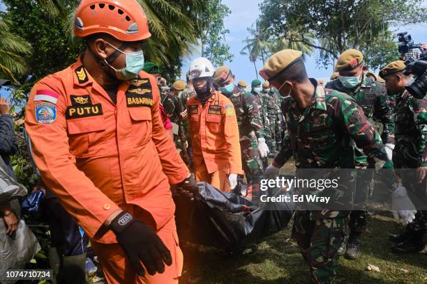 Rescue workers recover the body of a victim of the tsunami during a search at a resort hotel on December 24, 2018 in Tanjung Lesung, Indonesia. Over...