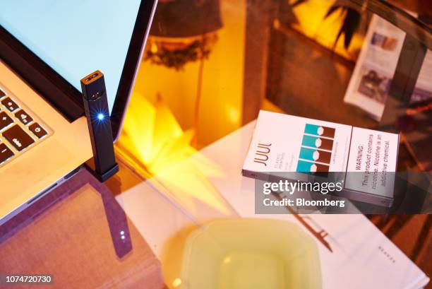 Juul Labs Inc. E-cigarette and package of Classic Menthol flavored pods are arranged for a photograph in the Brooklyn Borough of New York, U.S., on...