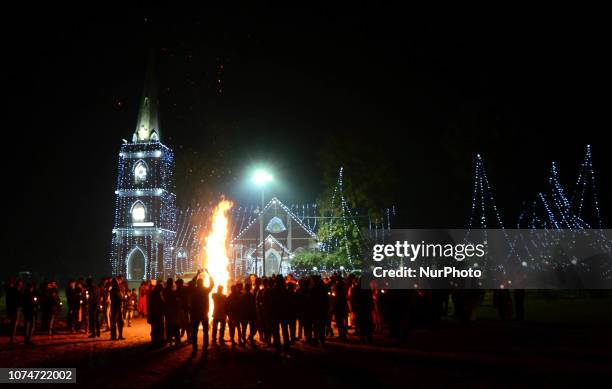 Indian Christian devotees take part in a bonfire ritual outside of St. Peter's Church in Allahabad on December 24 on Christmas Eve. Despite...