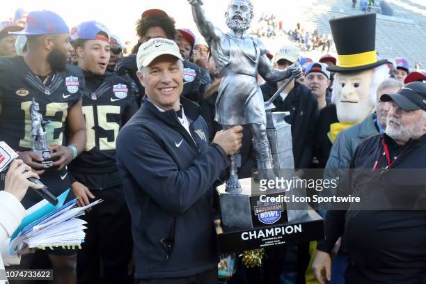 Wake Forest Demon Deacons head coach Dave Clawson holds the trophy after winning the Birmingham Bowl between the Memphis Tigers and the Wake Forest...