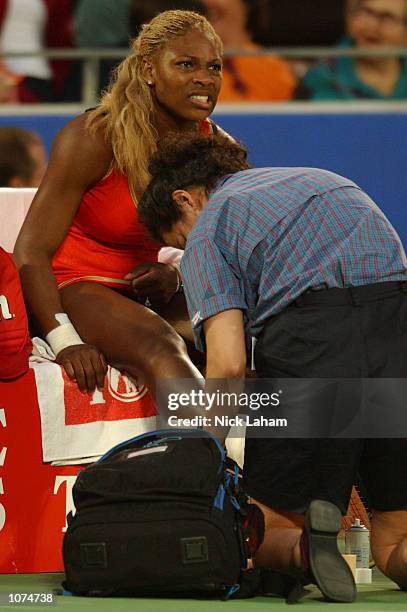 Serena Williams of the United States receives treatment after injuring her right ankle during her semi final against Meghann Shaughnessy of United...