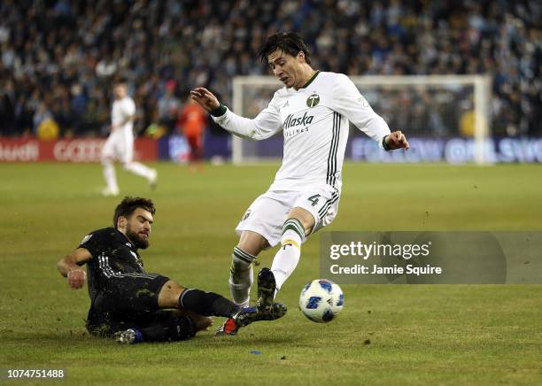 Graham Zusi of Sporting Kansas City slides as Jorge Villafana of Portland Timbers controls the ball during leg 2 pf the Conference Championship at...