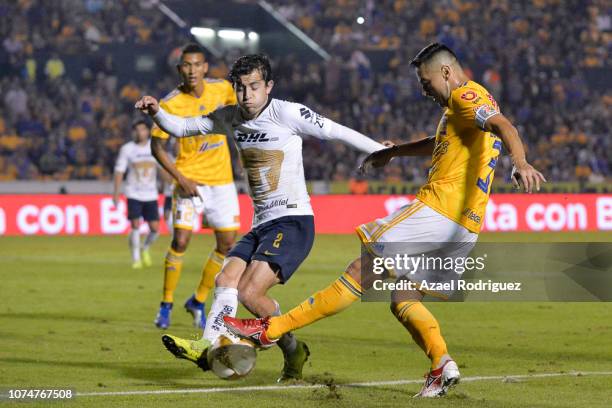 Juninho of Tigres fights for the ball with Alan Mozo of Pumas during the quarter finals first leg match between Tigres UANL and Pumas UNAM as part of...