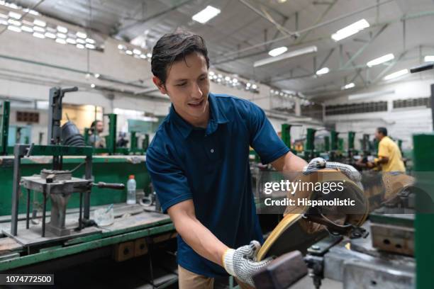 cheerful latin american cobbler making a boot at a shoe factory - shoe factory stock pictures, royalty-free photos & images