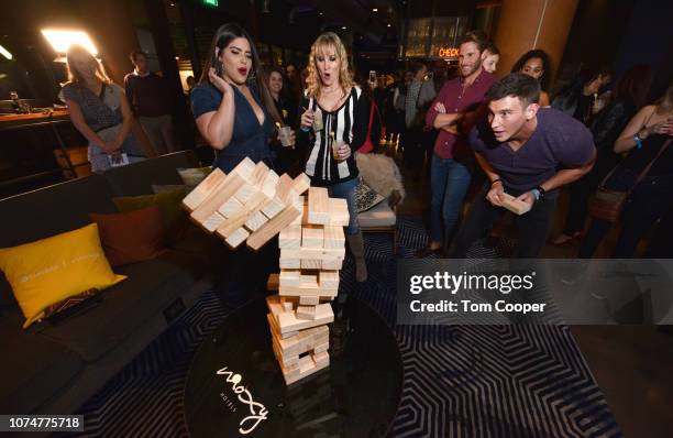 Host Denise Bidot and Blake Horstmann play jenga at the BumbleSpot #atthemoxy at Moxy Denver Cherry Creek on November 29, 2018 in Denver, Colorado.